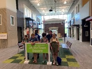 Student standing around a sign indoors during the Summer in the City experience