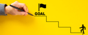 Icon of a person walking up steps to the "goal" at the top that is being drawn by a hand