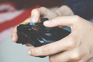 Close up of hands holding a gaming controller 