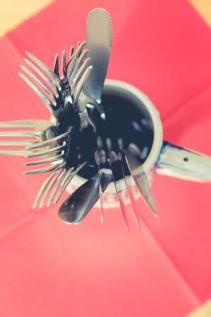 Overhead view of a mug with utensils in it