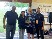 AFLS staff giving Rhonda Keene of the Pokagon fund a plaque 