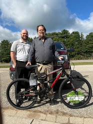 Frank Peasley and Brandon in front of a bicycle