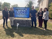 Group of people around the Zubke Dentistry sign