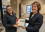 Casey holding her graduation certificate