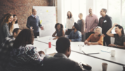 Group of people sitting around a table in an office conference room