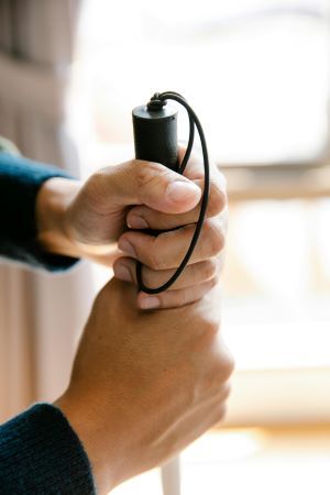 Close up of person's hands holding a cane