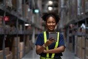 Woman in safety vest standing in a warehouse