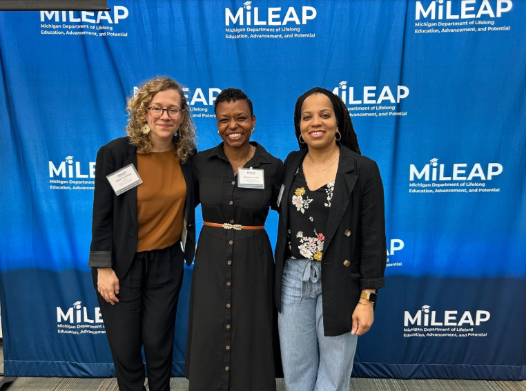 MIHI partners stand left to right in front of mileap banner; Sarah Szurpicki, Director,  Precious Miller, Jessica Robinson