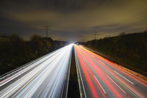 Time lapsed image of cars on a road showing red and yellow lights as lines 