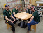 Cabinetmaking students around the table they made