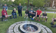Participants sitting around an outdoor campfire during the Great Wolf Lodge event