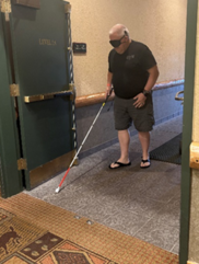 Man using a cane while walking down a hallway at Great Wolf Lodge