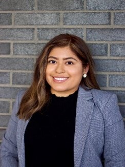 Diana Hernandez Garcia standing in front of a brick wall