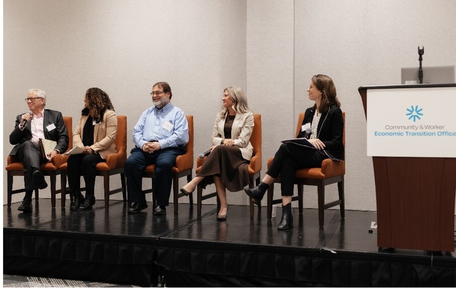 Panel speakers on stage during the Economic Transition Office celebration event