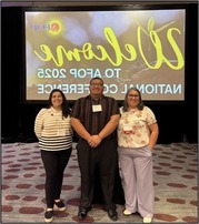 AFLS team standing in front of the AFOP Conference screen