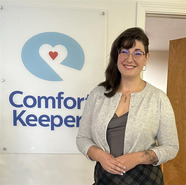 Adrienne Hope standing in front of a Comfort Care sign