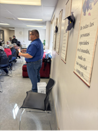 Man presenting to workers about support services