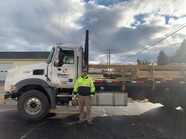 Randall standing in front of a truck