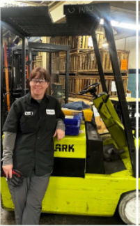 Maria standing next to machine