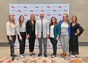 Michigan Works! Association staff in front of Michigan Works! banner