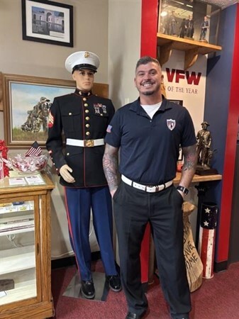 Jacob standing in front of statue in Navy uniform