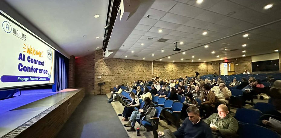 aiconnect conference with stage and crowd in seats