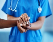 Close up of person in scrubs holding someone's hands