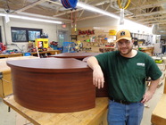 Andrew standing next to table he refinished