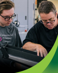 Student and instructor operating a printing press