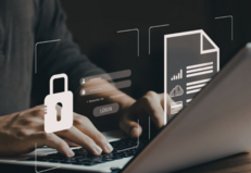 hands on laptop typing icons showing security lock and documents