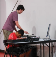 Two students practicing on keyboards