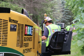 man on fork lift with trees around