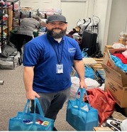 Jesus Ruiz Santos holding bags full of supplies