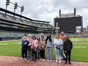 Group of student standing in front of the grass in Comerica Park