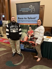 Ryan Maxwell (L) Maria Campbell (R) standing in front of Race to Talent banner