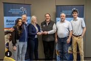 Miller Industries team holding award during GTS Michigan Works! Race to Talent event
