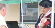 Person dressed in 1800s military gear during reenactment event