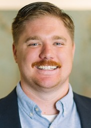 Evin Papuga, a white man with short hair and a moustache 