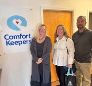 Tammy Carson, Lisa Morgan-Cole and Pat Muoio next to a Comfort Keepers sign