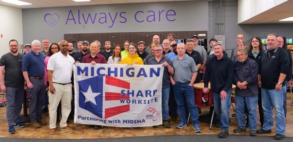 Norgren Employees Holding MSHARP Flag