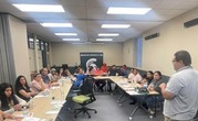Cristo speaking to several people sitting at tables
