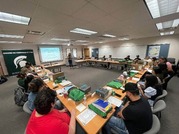 Several people sitting at rectangle tables