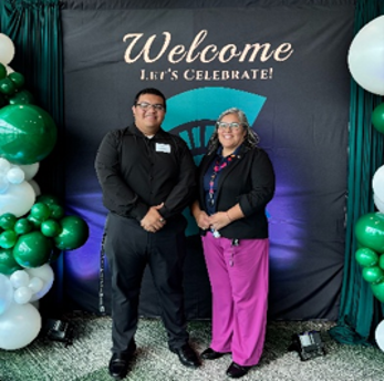 Cristo and Ginger standing in front of MSU CAMP welcome banner