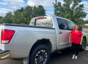 Eva standing next to her truck