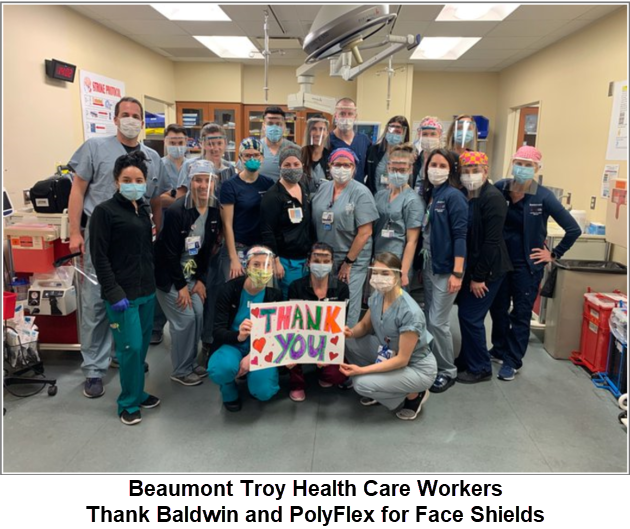 Health care workers with a big thank you sign