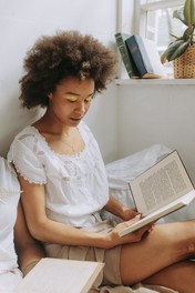 woman in white reading a book