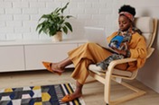 woman working from home in chair with laptop