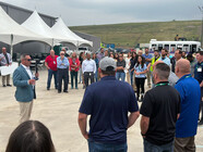 A crowd listening at Pine Tree Acres Landfill