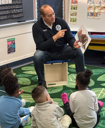 Clerk Forlini reads to the children during National Reading Month