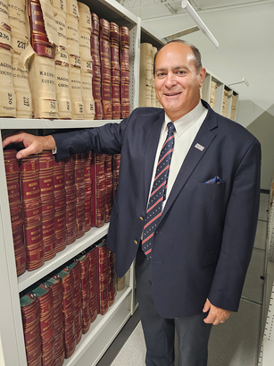 Clerk Forlini with Historical Register of Deeds Books